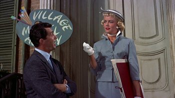 Movie still from “Artists and Models” (1955), directed by Frank Tashlin – A man and a woman talking in front of a building; Medium shot, Over the shoulder angle