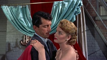 Movie still from “Artists and Models” (1955), directed by Frank Tashlin – A man and a woman standing next to each other; Medium shot, Low angle