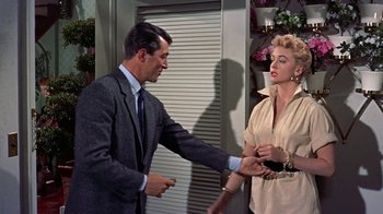 Movie still from “Artists and Models” (1955), directed by Frank Tashlin – A man and a woman are holding hands; Medium shot, Over the shoulder angle