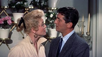 Movie still from “Artists and Models” (1955), directed by Frank Tashlin – A man and a woman standing next to each other; Close Up shot, Low angle