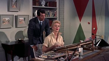 Movie still from “Artists and Models” (1955), directed by Frank Tashlin – A man and a woman sitting at a desk in front of a computer; Medium shot, Low angle