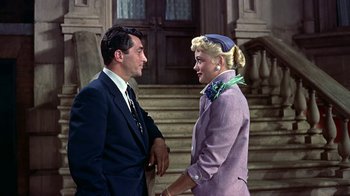 Movie still from “Artists and Models” (1955), directed by Frank Tashlin – A man and a woman standing next to each other on steps; Medium shot, Low angle