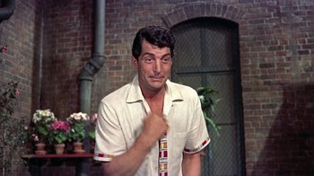 Movie still from “Artists and Models” (1955), directed by Frank Tashlin – A man wearing a white shirt and a neck tie; Medium shot, Over the shoulder angle