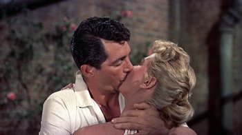 Movie still from “Artists and Models” (1955), directed by Frank Tashlin – A man and a woman kissing each other on the lips; Close Up shot, Low angle