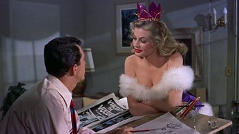 Movie still from “Artists and Models” (1955), directed by Frank Tashlin – A man and a woman sitting at a table; Medium shot, Over the shoulder angle