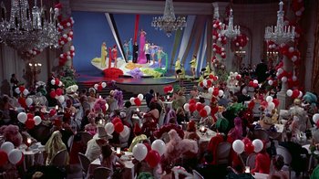 Movie still from “Artists and Models” (1955), directed by Frank Tashlin – A crowd of people sitting at tables in front of a stage; Extreme Wide shot, High angle