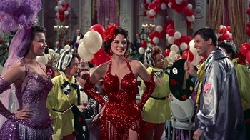 Movie still from “Artists and Models” (1955), directed by Frank Tashlin – A group of people in a room with balloons; Medium shot, Low angle