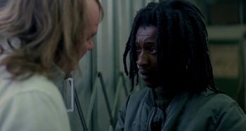 Movie still from “Babylon” (1980), directed by Franco Rosso – A man with dreads talking to another man; Close Up shot, Over the shoulder angle