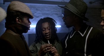 Movie still from “Babylon” (1980), directed by Franco Rosso – A group of men standing next to each other; Medium shot, Over the shoulder angle