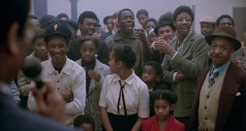 Movie still from “Babylon” (1980), directed by Franco Rosso – A group of people standing next to each other; Medium shot, High angle