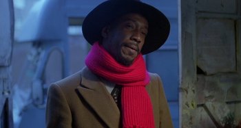 Movie still from “Babylon” (1980), directed by Franco Rosso – A man wearing a hat and a pink scarf; Close Up shot, Low angle