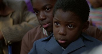 Movie still from “Babylon” (1980), directed by Franco Rosso – Two young boys are looking into the camera; Close Up shot, High angle