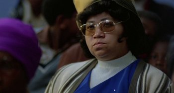 Movie still from “Babylon” (1980), directed by Franco Rosso – A person wearing a hat and sunglasses; Close Up shot, Low angle