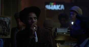 Movie still from “Babylon” (1980), directed by Franco Rosso – A man with a microphone in his mouth; Close Up shot, Low angle