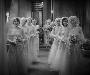 Movie still from “Bad Girl” (1931), directed by Frank Borzage – A black and white photo of a group of women in wedding dresses; Wide shot, High angle