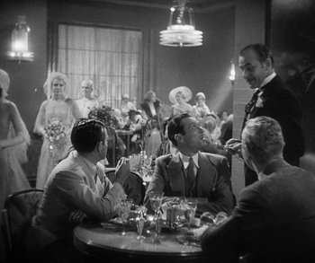 Movie still from “Bad Girl” (1931), directed by Frank Borzage – A black and white photo of people sitting at a table; Wide shot, High angle
