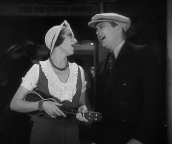 Movie still from “Bad Girl” (1931), directed by Frank Borzage – An older man and a woman are playing a ukulele together; Medium shot, Low angle