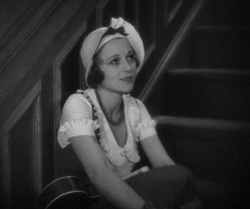 Movie still from “Bad Girl” (1931), directed by Frank Borzage – An old photo of a woman sitting on the stairs; Medium shot, High angle