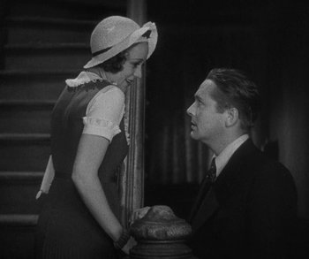 Movie still from “Bad Girl” (1931), directed by Frank Borzage – A man and a woman standing next to each other in front of a staircase; Medium shot, Low angle