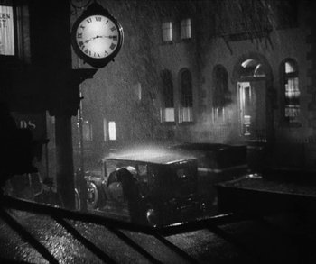 Movie still from “Bad Girl” (1931), directed by Frank Borzage – An old car parked on the side of the street; Extreme Wide shot, High angle