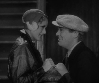 Movie still from “Bad Girl” (1931), directed by Frank Borzage – An older man and a young woman are holding hands; Close Up shot, Low angle
