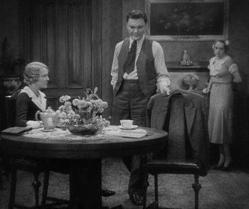 Movie still from “Bad Girl” (1931), directed by Frank Borzage – An old photo of a man and a woman at a table; Wide shot, High angle
