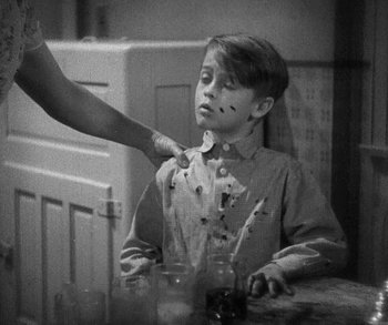 Movie still from “Bad Girl” (1931), directed by Frank Borzage – A young boy is being shaved by a woman; Medium shot, High angle