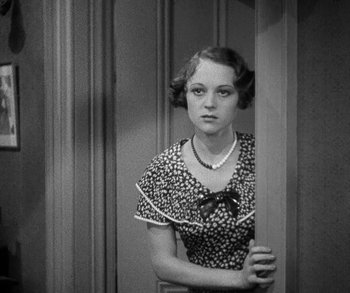 Movie still from “Bad Girl” (1931), directed by Frank Borzage – A young woman standing in front of a door; Medium shot, High angle
