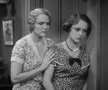 Movie still from “Bad Girl” (1931), directed by Frank Borzage – Two women standing next to each other in front of a wall; Medium shot, High angle