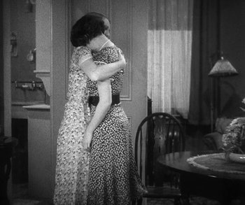 Movie still from “Bad Girl” (1931), directed by Frank Borzage – Two women embracing each other in an old photo; Medium shot, High angle