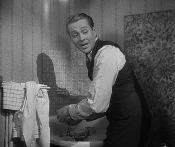 Movie still from “Bad Girl” (1931), directed by Frank Borzage – A black and white photo of a man washing his hands; Medium shot, Over the shoulder angle