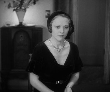 Movie still from “Bad Girl” (1931), directed by Frank Borzage – A woman wearing a black dress and a black hat; Close Up shot, High angle
