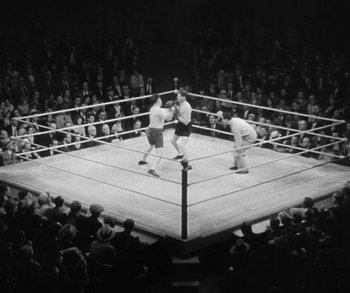 Movie still from “Bad Girl” (1931), directed by Frank Borzage – A boxing match is shown in a boxing ring; Extreme Wide shot, High angle