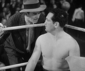 Movie still from “Bad Girl” (1931), directed by Frank Borzage – Two men in a boxing ring talking to each other; Medium shot, Low angle