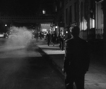 Movie still from “Bad Girl” (1931), directed by Frank Borzage – A black and white photo of a man walking down the street; Wide shot, Over the shoulder angle