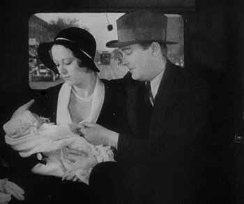 Movie still from “Bad Girl” (1931), directed by Frank Borzage – An old photo of a man and a woman in a car; Medium shot, High angle