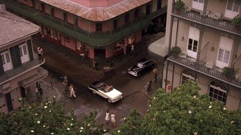 Movie still from “Blaze” (1989), directed by Ron Shelton – An aerial view of people walking on a street; Extreme Wide shot, Overhead angle