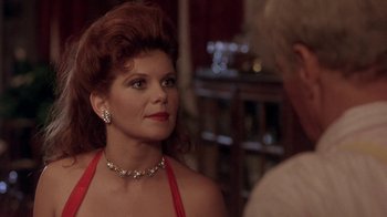 Movie still from “Blaze” (1989), directed by Ron Shelton – A person wearing a red dress; Close Up shot, Over the shoulder angle