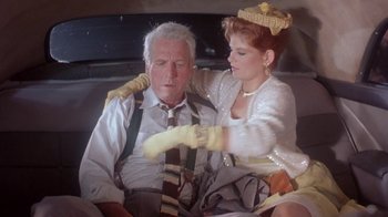 Movie still from “Blaze” (1989), directed by Ron Shelton – An older man and a young woman in a car; Medium shot, Low angle