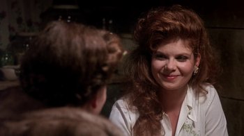 Movie still from “Blaze” (1989), directed by Ron Shelton – A woman with long red curly hair talking to another woman; Close Up shot, Over the shoulder angle
