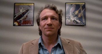 Movie still from “Body Double” (1984), directed by Brian De Palma – A person wearing a jacket; Close Up shot, Low angle