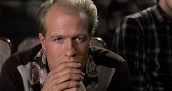 Movie still from “Body Double” (1984), directed by Brian De Palma – A person with his hand on his chin; Close Up shot, Low angle