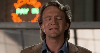 Movie still from “Body Double” (1984), directed by Brian De Palma – A person with his eyes closed; Close Up shot, Low angle