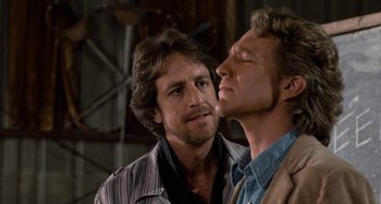 Movie still from “Body Double” (1984), directed by Brian De Palma – A man and a woman standing next to each other; Close Up shot, Over the shoulder angle