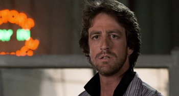 Movie still from “Body Double” (1984), directed by Brian De Palma – A person wearing a shirt; Close Up shot, Low angle