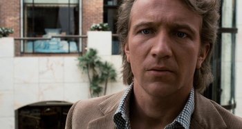 Movie still from “Body Double” (1984), directed by Brian De Palma – A person wearing a jacket; Close Up shot, Low angle