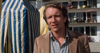 Movie still from “Body Double” (1984), directed by Brian De Palma – A person wearing a jacket; Close Up shot, Over the shoulder angle