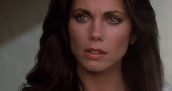 Movie still from “Body Double” (1984), directed by Brian De Palma – A woman's face with a serious look on her face; Close Up shot, Over the shoulder angle