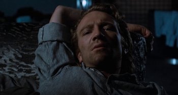 Movie still from “Body Double” (1984), directed by Brian De Palma – A person laying on the ground; Close Up shot, Low angle