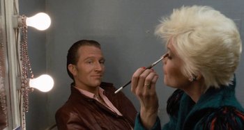 Movie still from “Body Double” (1984), directed by Brian De Palma – A man and a woman are looking at each other; Close Up shot, Over the shoulder angle